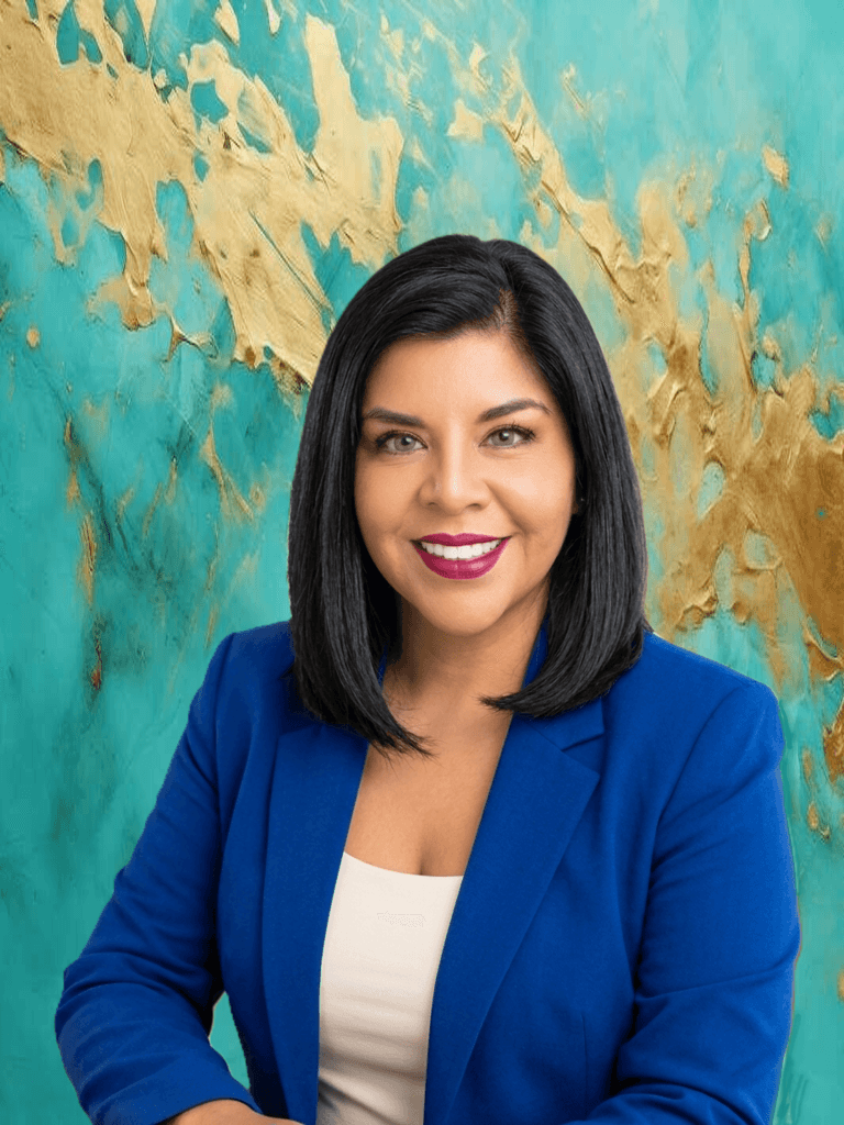 A professional executive portrait of the Wander Web Studio founder in a royal blue blazer against an abstract teal and gold textured artistic background.